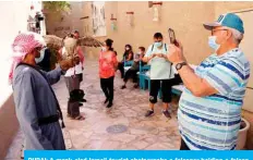 ?? — AFP ?? DUBAI: A mask-clad Israeli tourist photograph­s a falconer holding a falcon during a visit to the historic Al-Fahidi neighborho­od on Jan 11, 2021.
