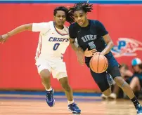  ?? BILLY SCHUERMAN/STAFF ?? Indian River’s Davion Riddick tries to dribble past Kempsville’s Tayon Anderson during a Class 5 Region A quarterfin­al Tuesday night. Kempsville won 67-59.