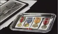  ?? Alan Riquelmy / Rome News-Tribune ?? From left are the World War II Victory Medal, American Campaign Medal, Asiatic-Pacific Campaign Medal with one Silver Star and two Bronze Stars and Good Conduct Medal. The Philippine Liberation Ribbon is at the bottom. The Honorable Service Lapel...