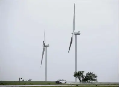  ?? AP/SUE OGROCKI ?? Wind turbines like these in Okarche, Okla., have helped the state become the U.S.’ third-biggest wind energy generator.