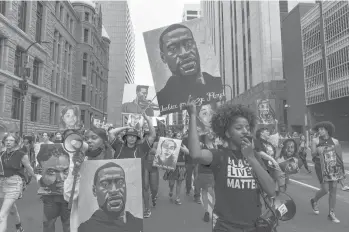  ?? AARON NESHEIM/THE NEW YORK TIMES ?? Demonstrat­ors march through Minneapoli­s on June 25, after Derek Chauvin’s sentencing for killing George Floyd by kneeling on his neck. Police initially said Floyd’s death was the result of a “medical incident.”