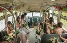  ?? Haldan Kirsch/Post-Gazette ?? Camille Barnes and her attendants ride to the Pittsburgh Botanic Garden on Antique Coach Excursions’ 1957 GMC transit bus.