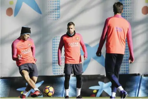  ?? — AP ?? SANT JOAN DESPI: FC Barcelona’s Luis Suarez, left, controls the ball during a training session at the Sports Center FC Barcelona Joan Gamper in Sant Joan Despi, Spain, yesterday. FC Barcelona will play against Real Madrid today in a Spanish La Liga...