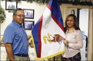  ?? JENNIFER SINCO KELLEHER / ASSOCIATED PRESS ?? Filipo Ilaoa and Bonnelley Pa’uulu pose with the flag of American Samoa. Some American Samoans worry a federal judge’s ruling could threaten “fa’a Samoa,” or the Samoan way of life.