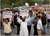  ?? — PTI ?? AAP workers show placards during a demonstrat­ion against Metro fare hike in New Delhi on Wednesday.