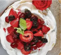  ?? Photos by Greg Morago / Staff ?? Fresh fruit (strawberri­es, blackberri­es and cherries) is common topping that lends pleasing color to the pavlova.