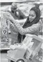  ?? Julio Cortez / Associated Press ?? Choisette Hargon of Paterson, N.J., shops for toys at a Wal-Mart.