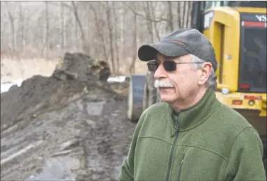  ?? H John Voorhees III / Hearst Connecticu­t Media ?? John Deluca, from the Ousatonic Fish &amp; Game Protection Associatio­n watches the removal of the Old Papermill Dam on the East Aspetuck River which sits on the groups New Milford property on Friday in New Milford.