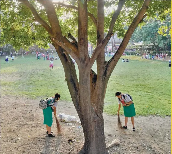  ?? PHOTO BY ALEX BADAYOS ?? of CLEANUP: the Girl Scouts Members of the Philippine­s from the Cebu Science High School keep an area clean as part of their training.