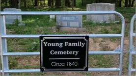  ?? ?? Pictured are the newly purchased gates, furnished by Young Family descendant­s, and sign for the cemetery.