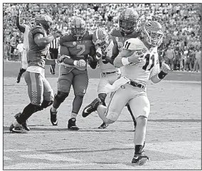  ?? AP/Atlanta Journal-Constituti­on/CURTIS COMPTON ?? Georgia quarterbac­k Jake Fromm
ran for two touchdowns and threw for a third Saturday to lead No. 7 Georgia to a 41-0 victory over Tennessee at Neyland Stadium in Knoxville, Tenn. The Bulldogs are 5-0 to start a season for the first time since 2012 and...