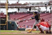  ?? AARON DOSTER — THE ASSOCIATED PRESS ?? Milwaukee's Christian Yelich hit for the cycle Wednesday against Cincinnati. It's the third time he's done it against the Reds.