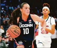  ?? Frank Franklin II / Associated Press ?? UConn’s Nika Muhl (10) drives past St. John’s Kadaja Bailey (30) during the second half on Wednesday.