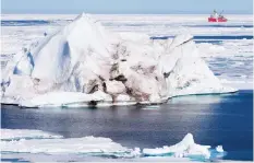  ?? THE CANADIAN PRESS/JONATHAN HAYWARD ?? A prominent climate scientist says Canada has fallen behind on its commitment to scientific research in the Arctic and it's having an effect on Canadian sovereignt­y in the north. A iceberg floating in the Baffin Bay above the arctic circle dwarfs the...