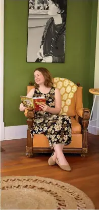  ?? Staff photo by Erin DeBlanc ?? ■ Author Amanda Langley sits in the sunroom of her home in the historic district of Texarkana, Ark., looking through edits of her first novel, "Chasing Humanity."