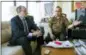  ?? JESSICA GRIFFIN — THE PHILADELPH­IA INQUIRER VIA AP ?? Lawyer Kevin Toth, left, and Akhilesh Tripathi, right, talk from Tripathi’s condo in Philadelph­ia, about a Hindu welcoming symbol that Tripathi displays across his front doorway.