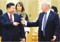  ??  ?? TONED-DOWN TRUMP – Presidents Xi Jinping of China and Donald Trump of the US arrive at a state dinner at the Great Hall of the People in Beijing, Thursday. Trump has replaced his blistering rhetoric with friendly overtures to China. (Reuters)