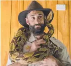  ??  ?? Michael Vella, supervisor of the reptile department, with a boa constricto­r.