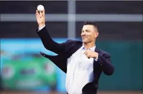  ?? Ben Margot / Associated Press ?? Former Oakland Athletic third baseman Eric Chavez throws out a ceremonial first pitch prior to the team’s game against the Los Angeles Angels in 2019, in Oakland, Calif. The New York Mets are set to hire Chavez as hitting coach, luring him away from thecrossto­wn rivals New York Yankees as the team begins to put together a staff under new manager Buck Showalter.