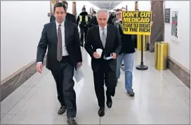 ?? TOM BRENNER/THE NEW YORK TIMES ?? A protester follows Sen. Bob Corker, R-Tenn., on Wednesday outside Senate offices on Capitol Hill in Washington. Corker, who voted against the initial Senate bill over deficit concerns, said he would support the legislatio­n.