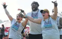  ?? Kin Man Hui / San Antonio Express-News ?? University Health System’s Mariah Martinez (from left), Rodney Boisley and Lindsey Perez celebrate a tug of war win.