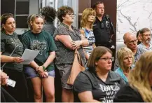  ?? Melissa Phillip / Houston Chronicle ?? People wearing “Santa Fe strong” T-shirts attend the Santa Fe ISD trustees meeting Monday, where the board approved installing metal detectors in the district’s schools