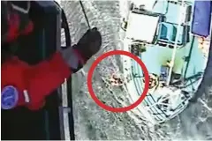  ??  ?? Rescue: Mr Berryman, circled, is winched aboard
