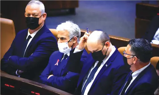  ?? (Olivier Fitoussi/Flash90) ?? DEFENSE MINISTER Benny Gantz, Foreign Minister Yair Lapid, Prime Minister Naftali Bennett and Justice Minister Gideon Sa’ar at the opening of the winter session at the Knesset, on Monday.