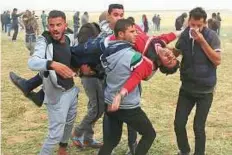  ?? AP ?? Another wounded Palestinia­n is evacuated after Israel used tear gas, rubber bullets and live ammunition on protesters.