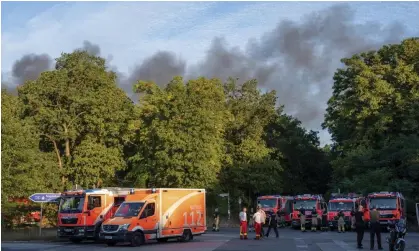  ?? ?? Fire engines and ambulances on standby at the Grunewald forest in Berlin. Photograph: Christophe Gateau/AP