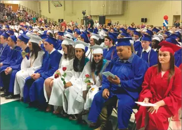  ?? Photo by Brendan McGair ?? Lincoln High School seniors sit as commenceme­nt ceremonies begin at the CCRI Lincoln campus on Friday.