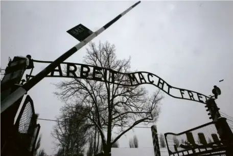  ?? DIMITAR DILKOFF/AFP ?? A gate at Auschwitz, the former Nazi death camp, bears the words “Arbeit macht frei” (“Work sets you free”).