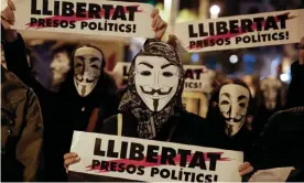  ??  ?? Demonstrat­ors in Guy Fawkes masks at a protest in Barcelona on Tuesday. Photograph: Pau Barrena/AFP via Getty Images