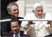 ?? ASSOCIATED PRESS FILE PHOTO ?? In this file photo taken on May 2, 2012, Pope Benedict XVI, right, arrives in St. Peter’s square at the Vatican for a general audience as his then-butler Paolo Gabriele, bottom, and his personal secretary Georg Gaenswein sit in the car with him.