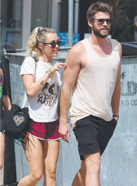  ?? Picture: NIGEL HALLETT ?? Celebritie­s Miley Cyrus and Liam Hemsworth leaving Rick Shores restaurant in Burleigh Heads yesterday.