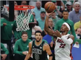  ?? MICHAEL DWYER — THE ASSOCIATED PRESS ?? The Miami Heat's Jimmy Butler (22) shoots against the Boston Celtics' Jayson Tatum (0) during the second half of Game 6of the Eastern Conference Finals on Friday in Boston.