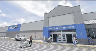  ?? ALAN DIAZ / ASSOCIATED PRESS ?? Walmart plans to add 1,000 online grocery locations, which help fill orders from customers buying their food on Walmart.com. The company expects to reach U.S. online revenue of $11.5 billion this year.