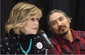  ?? The Canadian Press ?? Athabasca Chipewyan First Nation Chief Allan Adam looks on as Jane Fonda speaks during a press conference for indigenous rights Wednesday in Edmonton.