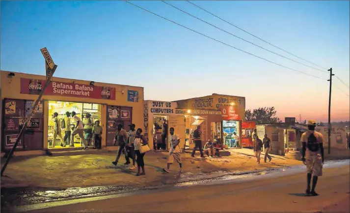  ??  ?? Nightfall: Estimates vary, but some organisati­ons reckon that up to half a million people live in Diepsloot. Research has shown that a quarter of a sample of 2 600 men in the township have probable depression, which often leads to problem drinking....