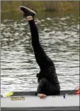  ?? STAN HUDY — SHUDY@DIGITALFIR­STMEDIA. COM ?? Saratoga Rowing Associatio­n freshman coxswain Grace Goodell does a handstand in her eight during Tuesday’s practice on Fish Creek, celebratin­g US Rowing’s Coxswain Appreciati­on Week.