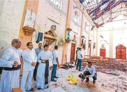  ?? AFP PIC ?? President Maithripal­a Sirisena (second from left) at Saint Sebastian’s Church in Negombo two days after a series of bomb attacks hit churches and hotels in Sri Lanka. Hatred between people of different religions will destroy faith in religion.