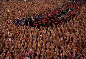  ?? (AP/Alvaro Barrientos) ?? Revelers raise their arms Wednesday as a band plays in the town hall square in Pamplona, Spain, while waiting for the launch of the “Chupinazo” rocket marking the opening of the 2022 San Fermin fiestas, nine days of nonstop partying and running of the bulls. More photos at arkansason­line.com/77spain22/.
