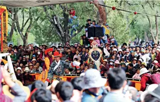  ??  ?? Tibetan opera has been very popular among local people in Tibet since its appearance. In the picture, Tibetan people throng around a performanc­e venue, marveling at the riveting opera play.