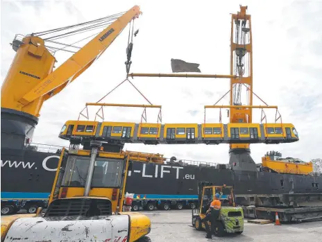  ??  ?? 2013: The first trams offloaded in the Port of Brisbane after arriving from Germany. Picture: Glenn Hampson