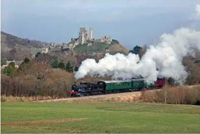  ??  ?? With the remains of Corfe Castle dominating the scene, T9 30120 heads south on March 20, 2014. (Andrew PM Wright)