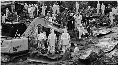  ??  ?? Rescue workers search for missing people at a landslide site caused by heavy rains in Pettimudy, in Kerala state, on August 8, 2020. (Photo:CNN)