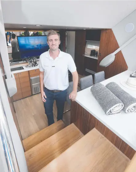  ?? Picture: MIKE BATTERHAM ?? Maritimo designer Tom Barry-Cotter on the X60 which is turning heads at the Sanctuary Cove Boat Show.