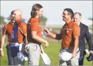  ?? Alastair Grant / Associated Press ?? Europe’s Francesco Molinari, right, and Tommy Fleetwood celebrate after winning a foursome match on the second day of the 42nd Ryder Cup at Le Golf National in Saint-Quentin-en-Yvelines, France, on Saturday.