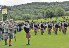  ?? 16_T35_Argyllshir­e Gathering_11 ?? The Duke of Argyll takes the salute from Angus MacColl and Oban High School Pipe Band.