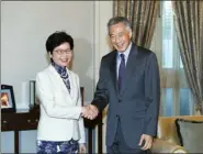  ?? INFORMATIO­N SERVICES DEPARTMENT ?? Chief Executive Carrie Lam Cheng Yuet-ngor greets the Prime Minister of Singapore Lee Hsien Loong before their meeting in Singapore on Thursday.